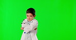 Portrait, children and a boy doctor on a green screen background in studio for healthcare or insurance. Kids, arms crossed and medicine with a male child looking serious about medical treatment