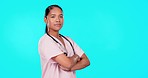 Crossed arms, doctor and medical woman in studio for insurance, trust and health service on blue background. Mockup space, healthcare and portrait of female worker for support, wellness and medicine