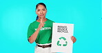 Portrait, poster and recycle with a woman on a blue background in studio holding a sign for conservation. Icon, sustainability and green with an attractive young female activist standing for ecology