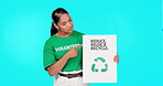 Portrait, poster and recycling with a woman on a blue background in studio holding a sign for conservation. Icon, sustainability or green with an attractive young female activist standing for ecology