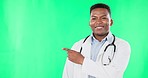Doctor, smile and black man pointing to green screen in studio isolated on a background mockup. Face portrait, healthcare professional and happiness for advertising, marketing or product placement.