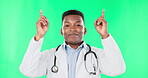 Doctor, face and black man pointing up to green screen in studio isolated on a background mockup. Portrait, healthcare professional and happiness for advertising, marketing and product placement.