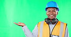 Mockup, construction and black man with space on a green screen isolated on a studio background. Happy, engineering and face portrait of African worker showing mock up on a backdrop for advertisement
