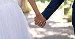 Wedding, marriage and couple holding hands in park for ceremony, commitment and celebration. Relationship, partnership and woman bride and groom man walking outdoor for romance, trust and love symbol