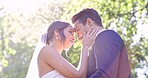 Summer wedding, couple and touch face in park, nature or support of celebration, marriage and flare below. Happy bride, groom and smile in garden for love, sunshine and celebrate commitment together