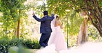 Wedding, dance or love with a husband and wife outdoor in a garden together dancing in tradition after a ceremony. Happy, celebration and relationship with a married couple having fun in a park