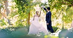 Wedding, dance and love with a married couple outdoor in a garden together dancing in tradition after a ceremony. Happy, celebration or relationship with a husband and wife having fun in a park