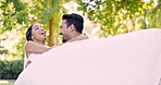 Love, wedding and a groom carrying his wife outdoor in a garden on their marriage day celebration or ceremony. Happy, smile and a married couple in a park with a man lifting his bride in tradition