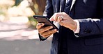 Cellphone, hands and closeup of man in a park typing a text message or networking on social media. Technology, outdoor and professional male browsing on the internet with a cellphone in nature.