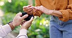 Hands, engagement ring and question with a man asking a woman, will you marry me, in a garden during summer. Love, romance and ring in a box with a couple bonding on a date in a park together closeup