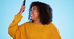 Angry, smartphone and black woman shouting, stress and social media with girl against a blue studio background. African American female, moody lady and cellphone with connection, upset and screaming