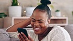 Phone, happy and black woman on a sofa with social media, joke or online comic in her home. Internet, meme and female relax in a living room while reading, browsing and enjoy streaming subscription