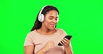 Green screen, happy woman and dancing to music with phone, freedom and radio online. Dance, female model and headphones for streaming on smartphone, listening to audio sound and energy for relax mood