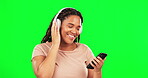Happy woman, green screen and dance with phone, headphones and hearing radio online. Dancing, female model and listening to music on mobile smartphone, streaming audio sound and energy for relax mood