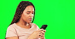 Phone, sad and mockup with a black woman on a green screen background in studio for communication. Mobile, contact and bad news with a female feeling guilty while typing a text message on chromakey