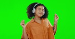 Green screen, woman and dance to happy music in studio, freedom or celebration in good mood. Headphones, female model and dancing to audio, sound and relax while listening to radio, streaming and joy