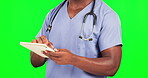 Black man, doctor typing and tablet on green screen, health and digital results with hands on studio background. Male surgeon, tech and healthcare medicine, online or electronic hospital schedule