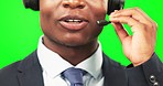 Black man, closeup and callcenter with green screen, CRM and contact us with face. Male customer service consultant, phone call and talk, help desk headset and hand holding mic on studio background