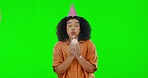 Birthday candle, happy and a woman on a green screen with a cupcake isolated on a studio background. Smile, face portrait and a girl making a wish and blowing out candles on cake for celebration
