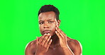 Black man, hand on face and green screen for serious skincare and self care dermatology. African male on studio background for clean skin, facial hygiene and cleaning or grooming for wellness