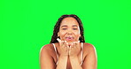 Woman, blowing kiss and green screen for skincare and self care dermatology. Happy female model on studio background for clean skin, facial glow and cosmetics with hands on face for wellness