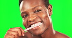 Black man, face and toothbrush, brushing teeth on green screen with hygiene and oral health for dental care. Happy male, portrait and routine with mouth cleaning and grooming on studio background