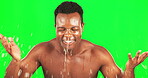 Black man, skincare and water splash on green screen for face with a smile and self care dermatology. African male on studio background for clean skin, hygiene and cleaning or grooming for wellness