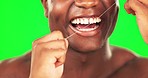 Black man, mouth and flossing, teeth whitening on green screen with hygiene and oral health for dental care. Happy male, closeup and morning routine with cleaning and grooming on studio background
