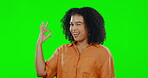 Ok, wink and smile with woman on green screen for happy, feedback and review. Smile, like and approval with female and positive hand gesture on studio background for agreement, vote and emoji