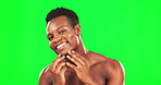 Black man, smile and skincare on green screen for face with self care dermatology. African male with hands on skin on studio background for clean facial, hygiene and cleaning or grooming for wellness