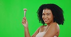 Green screen, makeup and woman blowing, brush and face grooming against a studio background. Portrait, female and person with happiness, treatment and beauty for confidence, luxury or cosmetics tools