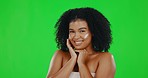 Face, green screen and woman with cream, smile and dermatology against a studio background. Female, confident and happy person with lotion, moisturizer and creme with beauty, skincare and cosmetics