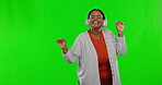 Black woman on green screen, headphones and dancing while listening to music, freedom and fun with happiness. Female is carefree, smile with entertainment and energy, mockup space and radio streaming