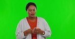 Frustrated, phone and woman on green screen with problem for text message, spam email and scam network. Communication, studio and senior female typing with glitch, error and angry with smartphone