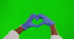 Heart sign, doctor or hands of woman with love gesture for hospital wellness, nurse support or medical clinic healthcare. Green screen emoji symbol, gloves or chroma key female on studio background
