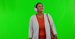 Happy, green screen and black woman with headphones, excited and celebration against a studio background. Female, smile and person with headset, streaming music and listening to sounds, radio and joy