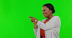 Green screen, mockup and happy woman pointing at product placement, deal or promotion isolated in a studio background. Marketing, advertising and excited female person showing sale or promo