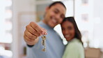 Couple, hands and kissing with keys in real estate, property or home owners in relationship together. Hand of happy woman and man holding key to apartment, house loan or mortgage investment and asset