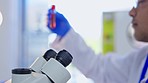 Blood sample, science and man with microscope in laboratory for medical research, dna testing and study. Healthcare, biotechnology and male scientist with test tube, liquid and vial for data analysis