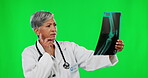 X ray, green screen and mature doctor analyzing results planning treatment and isolated in a studio background. Medical, research and woman healthcare professional reading MRI scan for surgery