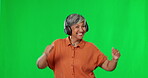 Dancing, green screen and happy woman listening to music  and dance in celebration isolated in a studio background. Winner, headphones and winning mature female with a positive energy for bonus