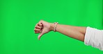 Review, bad and a thumbs down hand on a green screen isolated on a studio background. Vote, disagree and a person with a negative opinion, rejection and showing disapproval with a dislike gesture