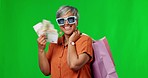 Happy woman, money and shopping bags on green screen for fashion or purchase against a studio background. Portrait of stylish female with cash and gift bag for buying luxury accessories on mockup