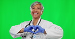 Doctor, heart and hands with woman on green screen for kindness, support and medicine. Healthcare, love and medical with female and gesture on studio background for emoji, cardiology and icon