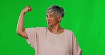 Happy, muscle and face of a woman on a green screen isolated on a studio background. Smile, fitness and portrait of a senior lady showing muscles, power and progress of training biceps on a backdrop