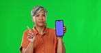 Woman, index and no by green screen with disapprove sign, smartphone and bad review of app in mock up. Senior female, phone ux and finger with blank mockup, tracking markers and negative opinion