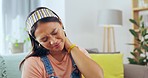 Asian woman, neck pain and burnout on living room sofa in stress, anxiety or discomfort at home. Young, tired or stressed female suffering bad ache, tension or strain from pressure, joint or muscle