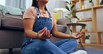 Woman, yoga and meditation on floor for spiritual wellness, health and zen exercise in living room at home. Calm asian female relaxing or meditating by sofa in lounge for stress relief or workout