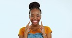 Happy, point and face of black woman with smile in studio for happiness, confidence and facial expression. Advertising, emoji mockup and portrait of girl on blue background with pointing hand gesture