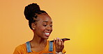 Phone, black woman and voice chat with smile in studio isolated on an orange background. Cellphone call, happiness or African person talk, speaking or discussion, conversation or record on speech app